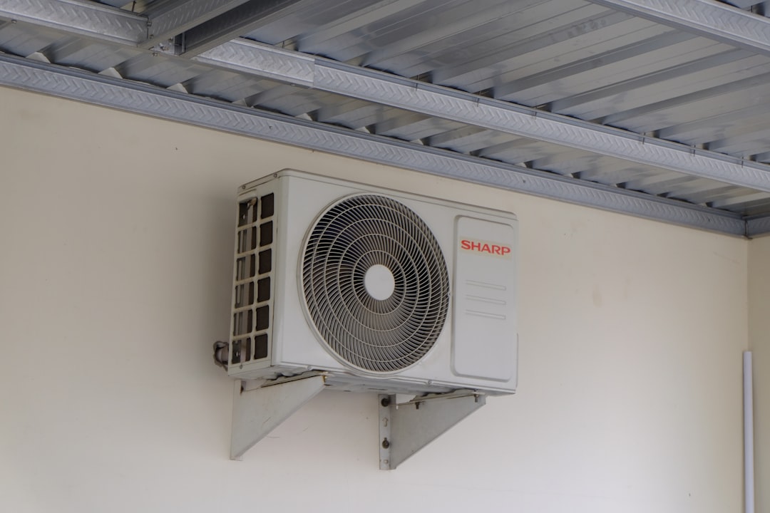 Outdoor air conditioning unit mounted on a wall, part of a home cooling and ventilation system commonly used in residential and commercial buildings.